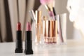 Different bright lipsticks on dressing table. Royalty Free Stock Photo