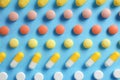 Different bright pills on color background