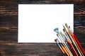 Different brushes to paint on dark wooden background, top view. Royalty Free Stock Photo