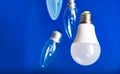 Different bulbs fall down. Electric lighting. Blurred background. Power saving LED lamps in comparison with incandescent lamps.