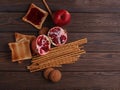 Different buns of fresh bread and spikelets of wheat on a brown vintage background Royalty Free Stock Photo