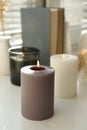 Different burning candles on window sill indoors Royalty Free Stock Photo