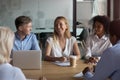 Different business people sitting together in boardroom desk and negotiating