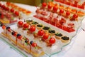different canapes in cups with sauce and tartlets with black caviar. Royalty Free Stock Photo