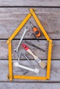 Different carpenter tools on wooden background.
