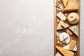 Different cheeses served on grey table, top view. Space for text Royalty Free Stock Photo