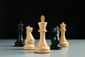 Different chess pieces on grey table against dark background Royalty Free Stock Photo
