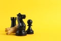 Different chess pieces on yellow background. Space for text Royalty Free Stock Photo