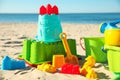 Different child plastic toys on beach, closeup