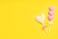 Different chocolate heart shaped lollipops on yellow background, flat lay. Space for text Royalty Free Stock Photo