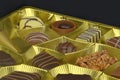 Different chocolate pralines in a golden box. Close up shot of chocolates box. Box of belgian pralines of different Royalty Free Stock Photo