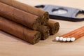 Different cigars on wooden desk