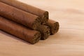 Different cigars on wooden desk