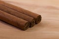 Different cigars on wooden desk