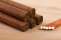 Different cigars on wooden desk