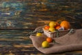 Different citruses in wicker basket on the canvas.