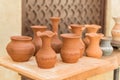 Different clay pots on a wooden table Royalty Free Stock Photo