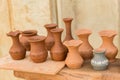 Different clay pots on a wooden table Royalty Free Stock Photo