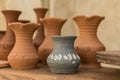 Different clay pots on a wooden table Royalty Free Stock Photo