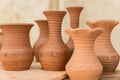 Different clay pots on a wooden table Royalty Free Stock Photo