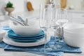 Different clean dishware, cutlery and glasses on white table in kitchen, closeup Royalty Free Stock Photo