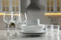 Different clean dishware and glasses on white marble table in kitchen Royalty Free Stock Photo