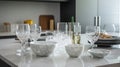 Different clean dishware and glasses on white marble table in kitchen, generative ai Royalty Free Stock Photo