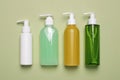 Different cleansers on olive background, flat lay with space for text. Cosmetic product