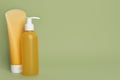 Different cleansers on olive background, space for text. Cosmetic product