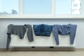 Different clothes drying on a radiator indoor Royalty Free Stock Photo