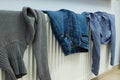 Different clothes drying on a radiator indoor Royalty Free Stock Photo
