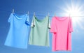 Different clothes drying on washing line against blue sky Royalty Free Stock Photo