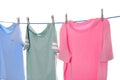 Different clothes drying on washing line against white background Royalty Free Stock Photo