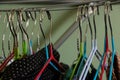 Different clothes on metal hangers in a room close-up Royalty Free Stock Photo