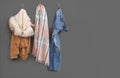 Different clothes and space for text on grey wall. Royalty Free Stock Photo