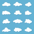 Different clouds on blue sky in origami design. Collection of white paper cut out cloud icons. Paper cloud. Weather symbols. Royalty Free Stock Photo