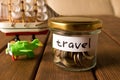 Different coins in glass jar. The concept of travel savings