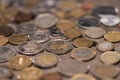 Different coins on wooden tabletop, pile of coins concept