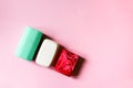 Different coloful soap on soft pink background Royalty Free Stock Photo