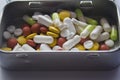 Different color pills in a metal box Royalty Free Stock Photo