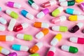 Different color pills on a pink background Royalty Free Stock Photo