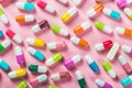 Different color pills on a pink background Royalty Free Stock Photo