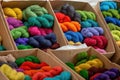 Different color yarns in boxes on the store shelf. Royalty Free Stock Photo