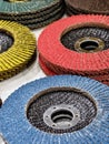 Different colored abrasive discs stacked on a table in a workshop during daytime Royalty Free Stock Photo