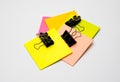 Different colored blank sticky notes with black binders on white background Royalty Free Stock Photo