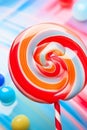 Different Colored Lollipops Swirling in Oil