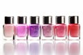 Different colored nail polish bottles in a row on white background Royalty Free Stock Photo