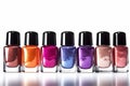 Different colored nail polish bottles in a row on white background Royalty Free Stock Photo