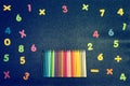 Different colored numbers and pencils on a bright background and writing space Royalty Free Stock Photo