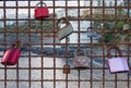 Different colored padlocks chained to a rusty fence against a seaside vacation background in evening light in funchal madeira Royalty Free Stock Photo